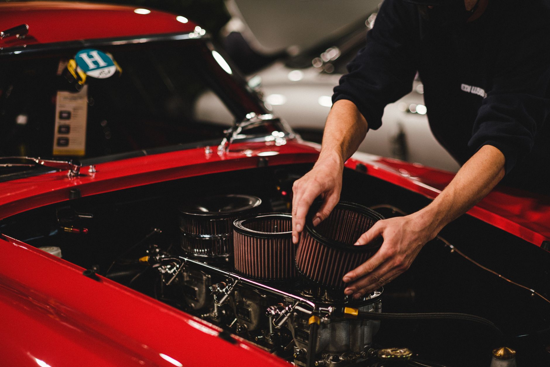 Bir teknisyenin motor bölmesinde hava filtresi üzerinde çalışması